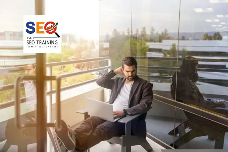 a man with a laptop on his lap on local SEO training with his coach