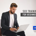 A Man With Laptop On His Lap Watching SEO Video Training For Beginners