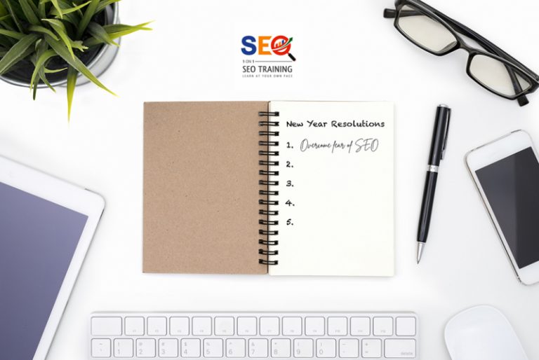 New Year Resolutions Concept On White Desk With Glass, Pen, Cellphone., Tablet, Keyboard and A Mouse Promoting New Year Resolution – Overcome Your Fear of SEO