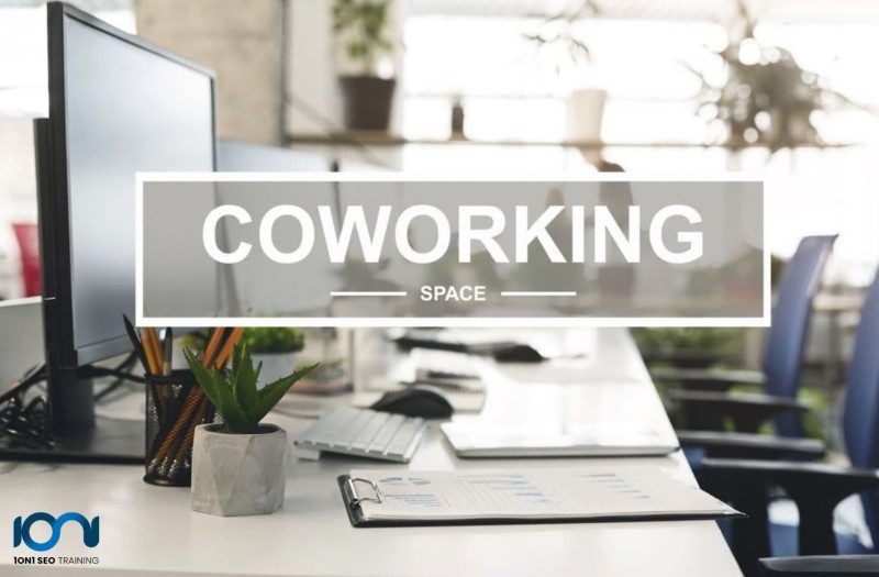 Coworking space SEO with a laptop, keyboard, mouse, papers, pencils and office chairs promoting Does Renting a Virtual Office Hurt Your SEO