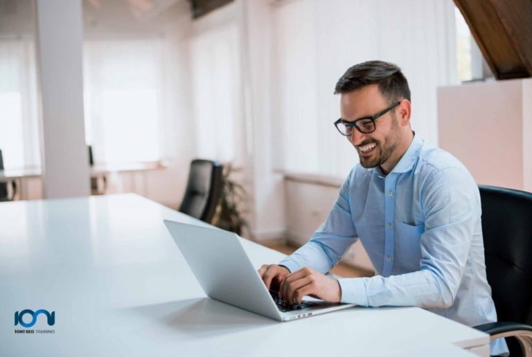 A happy male in front of a laptop learning SEO online on How SEO Specialist Training Can Land You a Better Career