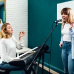 SEO for music, a voice instructor guiding her student through practice.