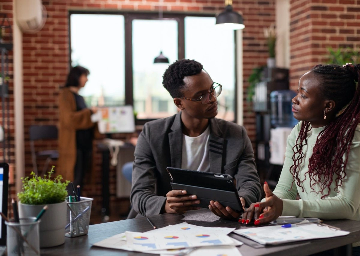 Two people at a desk, having a focused conversation during an SEO training session